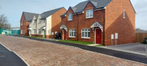 Image of two red brick semi-detached houses on a street